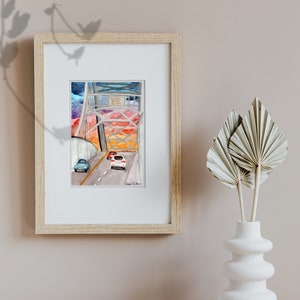 May include: A watercolor painting of a bridge with cars driving on it. The bridge is painted in shades of gray and the sky is a vibrant orange and pink sunset. The text "Welcome to the City" is on a sign above the bridge.