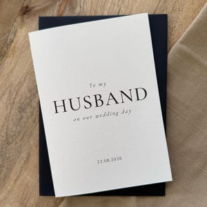 May include: A set of three ceramic mugs with a speckled, matte finish. The mugs are in shades of cream, light gray, and dark gray. Each mug has a simple, minimalist design and a rounded handle.