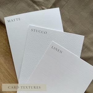 May include: Three white cardstock samples with different textures: matte, stucco, and linen. The word "MATTE" is printed in black on the top left card, "STUCCO" on the middle card, and "LINEN" on the bottom right card. The words "CARD TEXTURES" are printed at the bottom.
