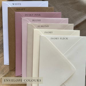 May include: A stack of envelopes in various colors, including white, kraft, dusky pink, blush, almond, ivory, and ivory fleck. The text "ENVELOPE COLOURS" is at the bottom. The envelopes are arranged in a layered fashion.