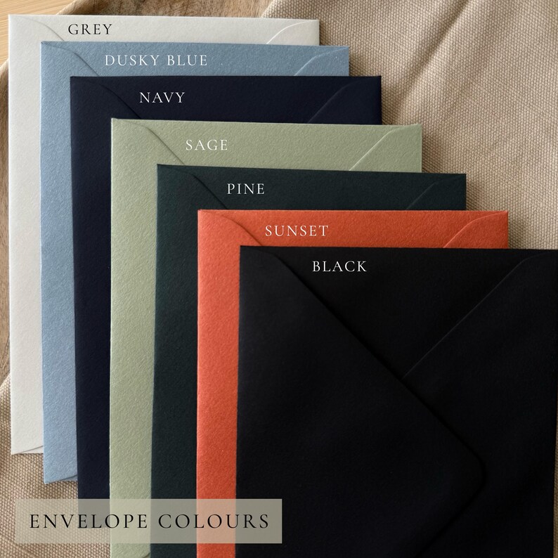 May include: A collection of colorful envelopes in various shades, including grey, dusky blue, navy, sage, pine, sunset, and black. Each envelope is labeled with its respective color name. The text "ENVELOPE COLOURS" is displayed at the bottom of the image.