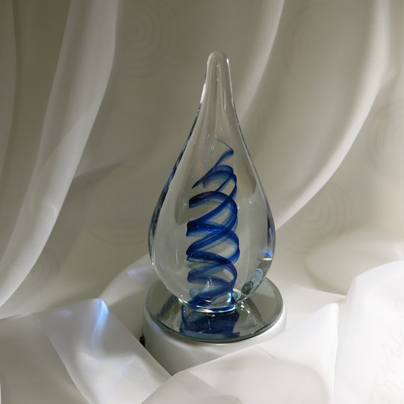 Vintage glass paperweight with blue swirls