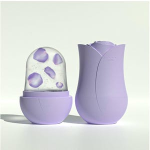 May include: A lavender-colored ice mold shaped like a rose, with a separate dome-shaped container holding ice with purple petals. The rose-shaped mold has a "max" marking. The design is modern and minimalist, suitable for making decorative ice.