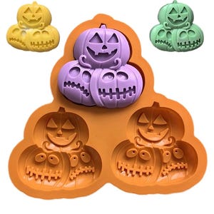 May include: Orange silicone mold with six pumpkin-shaped cavities. The mold features three stacked pumpkins with jack-o'-lantern faces and three single pumpkins with jack-o'-lantern faces.