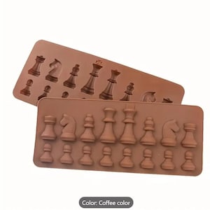 May include: A brown silicone mold for making chocolate chess pieces. The mold is divided into two sections, one with the larger pieces and the other with the smaller pieces. The mold is made of food-grade silicone and is dishwasher safe.