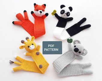 May include: Four crocheted animal bookmarks: a fox, a panda, a giraffe, and a koala. The bookmarks are all in different colors and have cute faces. The text "PDF PATTERN" is visible in the center of the image.