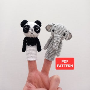 May include: Two finger puppets, one panda and one elephant, are worn on a person's fingers. The panda is black and white, and the elephant is gray. The text "PDF PATTERN" is on a red rectangle.