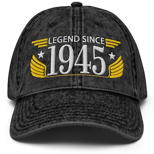 May include: Black distressed denim baseball cap with yellow embroidered wings and the text "LEGEND SINCE 1945".