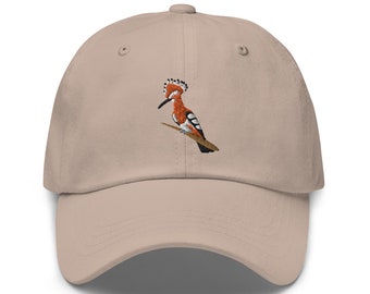 May include: A beige baseball cap with an embroidered image of a hoopoe bird with orange, black, and white feathers.
