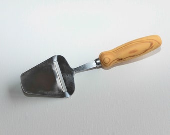 Cheese slicer with olive ash