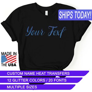 May include: Black t-shirt with the text "Your Text" in blue glitter. The shirt is made in the USA and comes in multiple sizes.  Custom name heat transfers are available in 12 glitter colors and 20 fonts.
