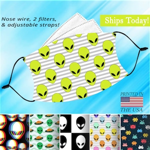 May include: A face mask with a white and gray striped background and a repeating pattern of green alien heads. The mask has adjustable straps and a nose wire. The text "Ships Today!" and "Printed in the USA" is visible in the image.