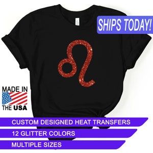 May include: Black t-shirt with a red glitter Leo zodiac sign. The text "SHIPS TODAY!" is in a blue box at the top of the image. The text "MADE IN THE USA" is in a red, white, and blue box at the bottom left of the image. The text "CUSTOM DESIGNED HEAT TRANSFERS" is in a white box at the bottom of the image. The text "12 GLITTER COLORS" is in a white box below the previous text. The text "MULTIPLE SIZES" is in a white box below the previous text.