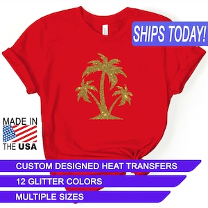 May include: Red t-shirt with a gold glitter palm tree design. The text "SHIPS TODAY!" is in a blue box at the top of the image. The text "MADE IN THE USA" is in a blue box at the bottom left of the image. The text "CUSTOM DESIGNED HEAT TRANSFERS" is in a blue box at the bottom center of the image. The text "12 GLITTER COLORS" is in a blue box below the previous text. The text "MULTIPLE SIZES" is in a blue box below the previous text.