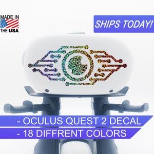 May include: A white Oculus Quest 2 virtual reality headset with a holographic eye decal. The decal features a circuit board design with a circular eye in the center. The text "OCULUS QUEST 2 DECAL" and "18 DIFFRENT COLORS" is displayed below the headset.