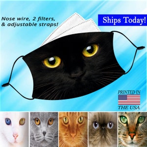 May include: Black face mask featuring a close-up of a black cat's face with bright yellow eyes. The mask includes a nose wire, two filters, and adjustable straps. The text reads "Nose wire, 2 filters, & adjustable straps!" and "PRINTED IN THE USA".