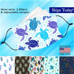 May include: A white face mask with a blue and purple sea turtle pattern. The mask has adjustable straps, a nose wire, and two filters. The text "Ships Today!" and "Printed in the USA" is visible in the image.