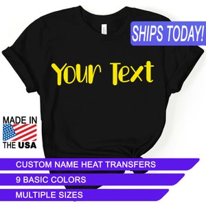 May include: Black t-shirt with the text "Your Text" in yellow. The shirt is made in the USA and is available in multiple sizes and colors.