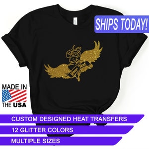 May include: Black t-shirt with a gold glitter design of a heart with wings and the text "Your Text". The design is a heat transfer. The shirt is available in multiple sizes and 12 glitter colors.