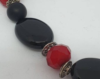 This one of a kind necklace is made us Onyx, Crystals and metal with a magnetic clasp