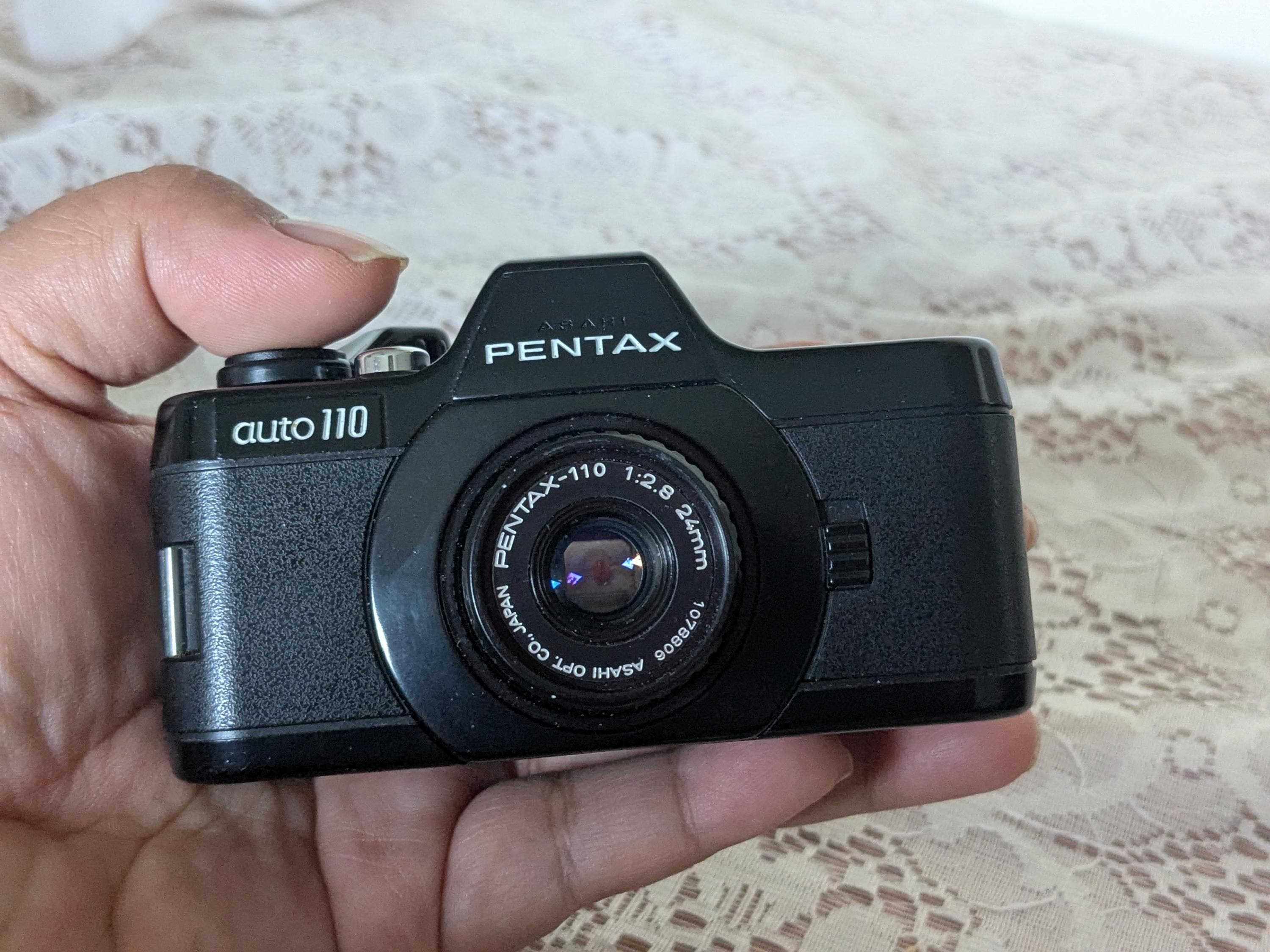 Lot - A Pentax auto110 miniature camera and accessories with leather