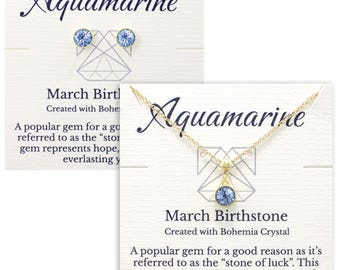May include: Aquamarine birthstone necklace and earrings set. The necklace features a light blue crystal pendant on a gold chain. The earrings are small and feature light blue crystals. The packaging includes a card with the text "Aquamarine March Birthstone Created with Bohemia Crystal A popular gem for a good reason as it's referred to as the "stone of luck". This gem represents hope, happiness and everlasting youth."