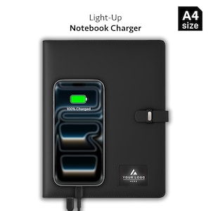 May include: A black A4 size notebook charger with a light-up logo area. A smartphone is placed on the cover, displaying a green battery icon and the text 100% Charged. The notebook features a side strap closure and a rectangular logo plate.