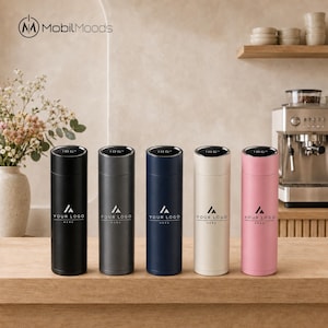 May include: Five cylindrical vacuum-insulated water bottles in black, dark grey, navy blue, cream, and pink. Each bottle features a digital temperature display on the lid and the text "YOUR LOGO HERE" printed in white on the front surface.
