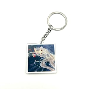 May include: A silver keychain with a square acrylic charm featuring an anime character with long white hair and the text "I'm not demure I'm insane".