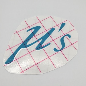 May include: A blue vinyl decal with the text "Y's" in a cursive font. The decal is on a white sheet with a grid pattern.