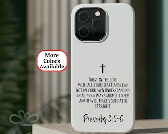 May include: White iPhone case with a black cross and the text "TRUST IN THE LORD WITH ALL YOUR HEART AND LEAN NOT ON YOUR OWN UNDERSTANDING IN ALL YOUR WAYS SUBMIT TO HIM AND HE WILL MAKE YOUR PATHS STRAIGHT Proverbs 3:5-6"