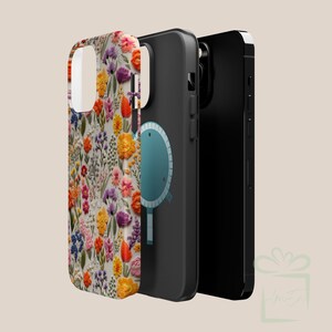May include: A black phone case with a floral design and a blue circle with a white outline. The case is made of a hard plastic material and has a smooth finish.