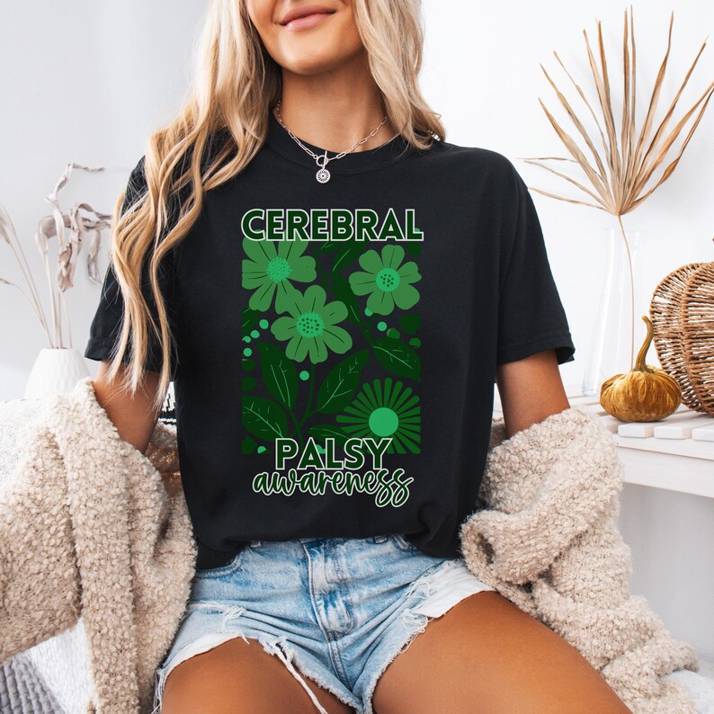 May include: Black t-shirt with green floral design and the text "Cerebral Palsy Awareness".