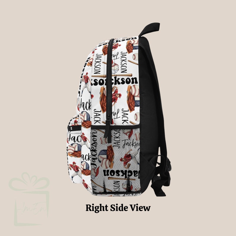 May include: White backpack with a baseball themed print. The print features baseball bats, gloves, balls, and the name "Jackson" repeated throughout. The backpack has a black zipper and black straps.