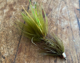 May include: A green and brown fly fishing lure with a gold bead head and a hook.
