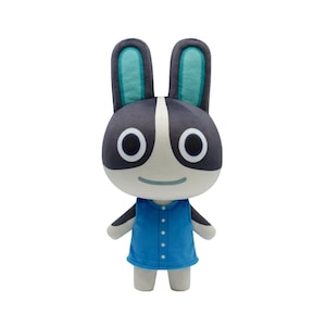 May include: A plush toy rabbit with a black and white face, large round eyes, and long ears with teal interiors. It wears a blue button-up shirt and has small arms and legs. The toy is designed to resemble a cartoon character.