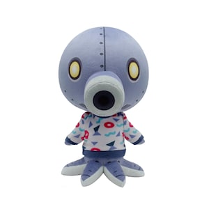 May include: A plush toy octopus with a round, pale blue head and large yellow eyes. It has a cylindrical mouth and a patterned shirt with red, blue, and white shapes. The octopus has six blue tentacles.