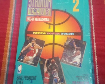 May include: A blue and yellow box for 1993-94 Topps Stadium Club NBA Basketball trading cards. The box features a basketball with the text "Topps Super Color" and images of basketball players. The box is labeled "Series 2".