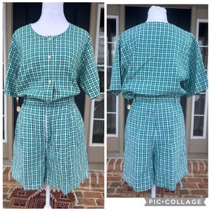 May include: A two-piece green and white checkered outfit. The top has short sleeves and buttons down the front. The shorts have a drawstring waist. The outfit is displayed on a mannequin.