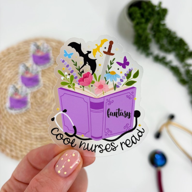 May include: A clear sticker featuring a purple book with the word "fantasy" on the cover. The book is open, revealing flowers, butterflies, and a sword. The text "cool nurses read" is written around a stethoscope.