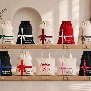 A collection of white drawstring bags with various designs and text, displayed on a shelf.