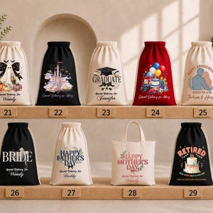 A collection of white drawstring bags with various designs and text printed on them, displayed on a shelf.