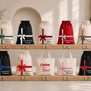 A collection of white drawstring bags with various designs and text, displayed on a shelf.