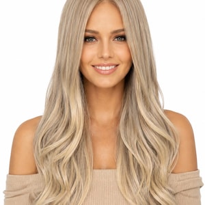 May include: A long, layered wig featuring a center part and soft, loose waves. The hair color is a multi-dimensional blend of cool ash blonde and lighter platinum highlights, creating a natural, rooted appearance with a smooth, flowing texture.