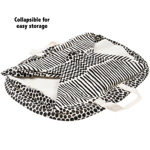 May include: A black and white patterned fabric storage basket with handles. The basket is folded and the text "Collapsible for easy storage" is visible.