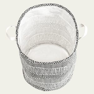 May include: A black and white patterned fabric storage bin with two handles. The bin is empty and has a white interior.