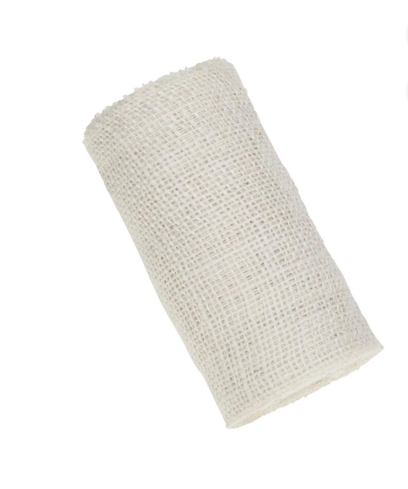 May include: A roll of white hessian ribbon. The ribbon is made from a natural fibre and has a rough texture.
