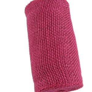 May include: A roll of pink hessian ribbon. The ribbon is made of a woven fabric with a rough texture.