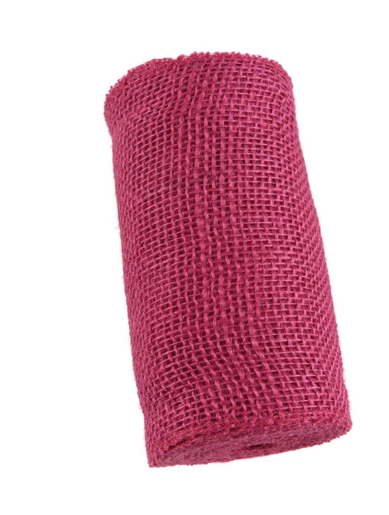 May include: A roll of pink hessian ribbon. The ribbon is made of a woven fabric with a rough texture.