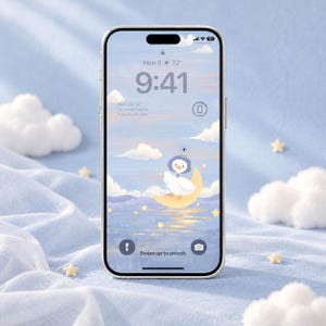 May include: A smartphone displaying a digital wallpaper of a white duck wearing a blue bonnet, sitting on a yellow crescent moon above a purple sea with floating yellow stars, set against a light blue sky with white clouds and time display.